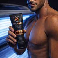 Man Holding Forge Black Reserve Tanning Lotion Bottle